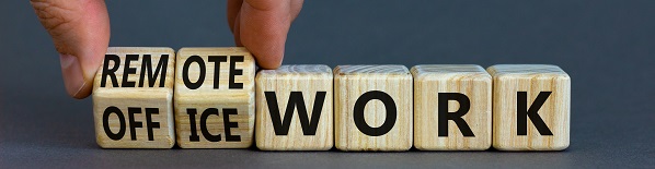 Remote or office work symbol. Businessman turns cubes and changes words 'office work' to 'remote work'. Beautiful grey background. Business, remote or office working concept, copy space.